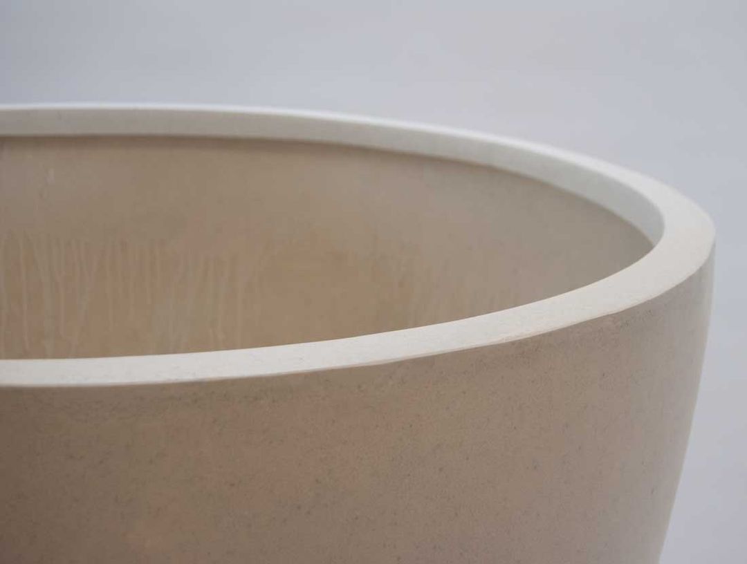 Detailansicht des oberen Randes eines runden, konischen Pflanzkübels aus Fiberglas in Perlmuttweiß mit Blick ins Innere